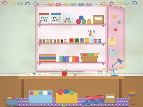 An open craft cupboard with three crowded shelves: jars of buttons and pom-poms, reels of thread and ribbon, balls of wool, paint pots, brushes, paper stacks and felt squares; below it a craft table with a bead tray, a tomato pincushion, scissors, a paper chain and a lamp, and a cat on a stool.