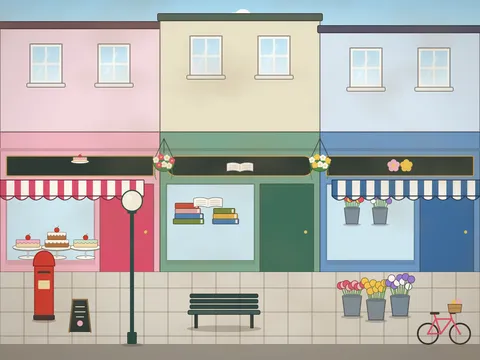 A small-town high street with three shops: a pink bakery with cakes in the window and a striped awning, a green bookshop with stacked books, and a blue florist with buckets of flowers outside, flats above with window boxes, hanging baskets, a red post box, a lamp post, a bench, a bicycle and a sandwich board.